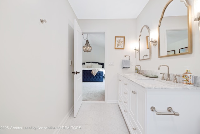 1232 Chemung Forest Dr, Howell, MI 48843 - ensuite bathroom featuring double vanity and baseboards