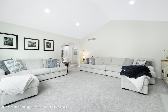1232 Chemung Forest Dr, Howell, MI 48843 - living area with arched walkways, carpet, recessed lighting, high vaulted ceiling, and baseboards