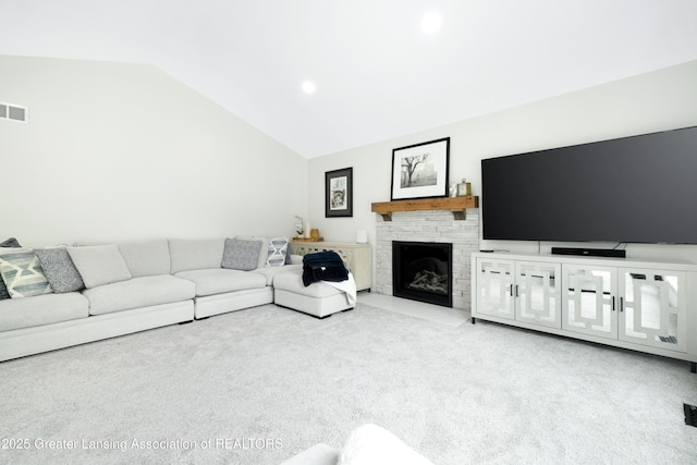 1232 Chemung Forest Dr, Howell, MI 48843 - carpeted living room with vaulted ceiling, a stone fireplace, and recessed lighting