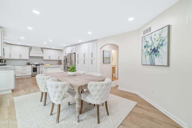 1232 Chemung Forest Dr, Howell, MI 48843 - dining room with arched walkways, light wood-style floors, baseboards, and recessed lighting