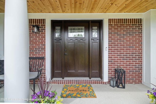 1232 Chemung Forest Dr, Howell, MI 48843 - view of exterior entry featuring brick siding and covered porch
