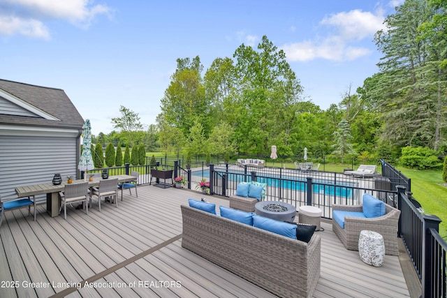 1232 Chemung Forest Dr, Howell, MI 48843 - wooden deck featuring an outdoor living space with a fire pit, outdoor dining area, and view of wooded area