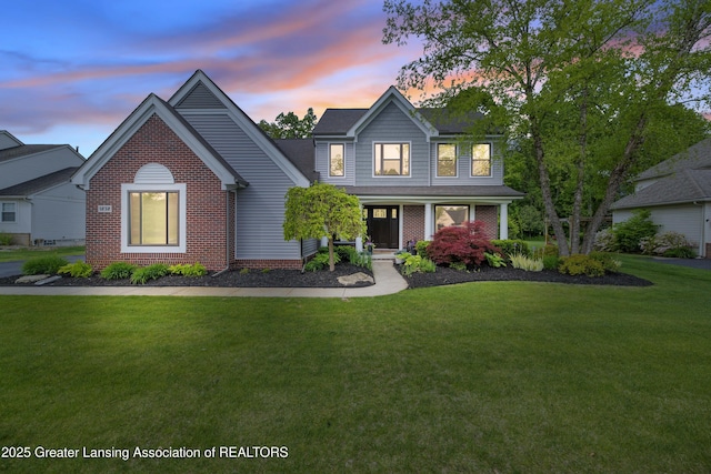 1232 Chemung Forest Dr, Howell, MI 48843 - traditional-style home featuring a yard, brick siding, and covered porch