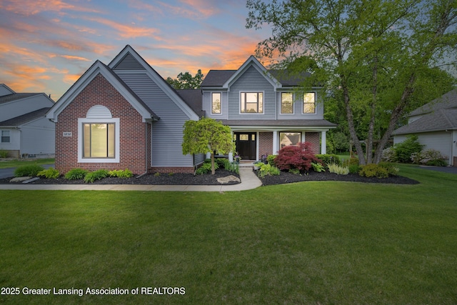 1232 Chemung Forest Dr, Howell, MI 48843 - traditional-style house with a yard, brick siding, and a porch