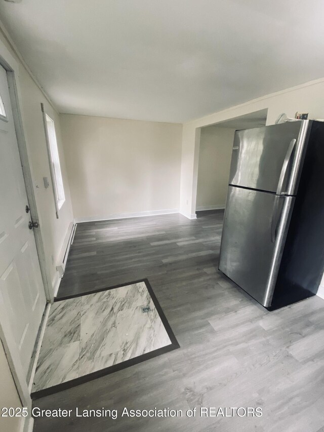 3319 Westmont Ave, Lansing, MI 48906 - kitchen featuring freestanding refrigerator, wood finished floors, healthy amount of natural light, and baseboards