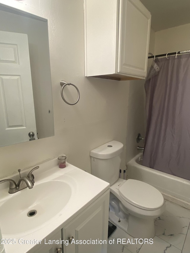 3319 Westmont Ave, Lansing, MI 48906 - full bath featuring toilet, vanity, shower / bath combo with shower curtain, and marble finish floors