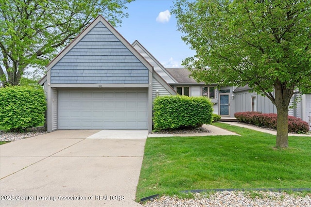 1101 Boulder Ct Unit 48, Lansing, MI 48917 - view of front of home featuring driveway, a garage, and a front yard