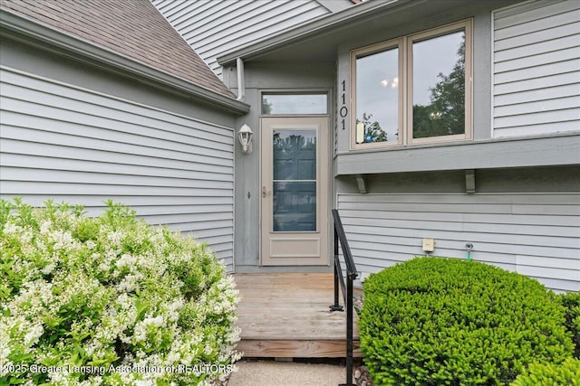 1101 Boulder Ct Unit 48, Lansing, MI 48917 - property entrance featuring a shingled roof and a deck