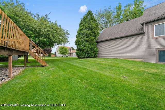 1101 Boulder Ct Unit 48, Lansing, MI 48917 - view of green lawn with stairway and a wooden deck