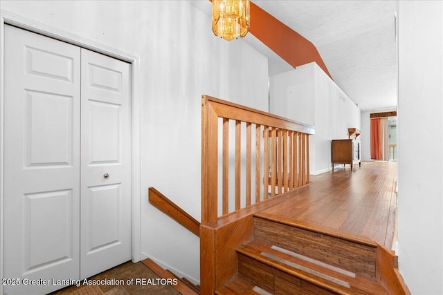 1101 Boulder Ct Unit 48, Lansing, MI 48917 - stairs featuring baseboards and a chandelier