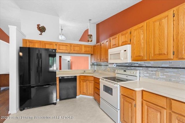 1101 Boulder Ct Unit 48, Lansing, MI 48917 - kitchen with black appliances, a sink, tasteful backsplash, light countertops, and light flooring