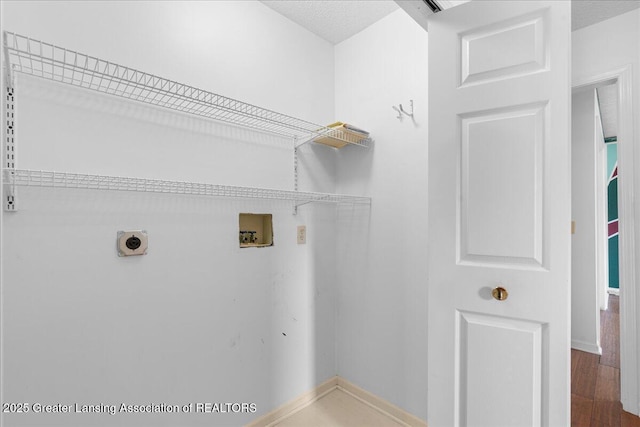 1101 Boulder Ct Unit 48, Lansing, MI 48917 - laundry area featuring washer hookup, electric dryer hookup, baseboards, and wood finished floors