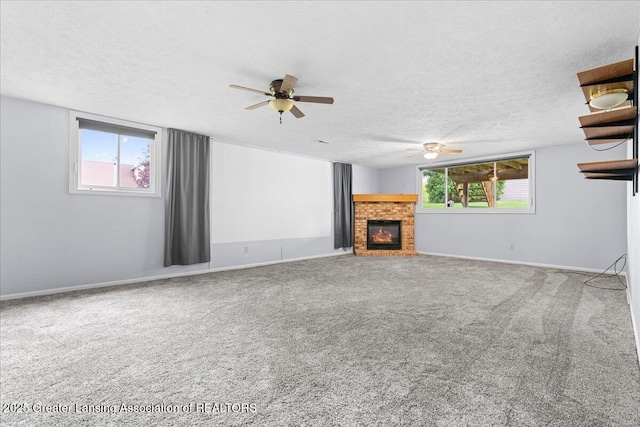 1101 Boulder Ct Unit 48, Lansing, MI 48917 - unfurnished living room with a ceiling fan, a textured ceiling, a brick fireplace, carpet, and baseboards