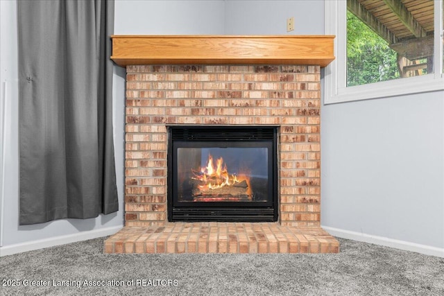 1101 Boulder Ct Unit 48, Lansing, MI 48917 - detailed view of carpet flooring, a fireplace, and baseboards