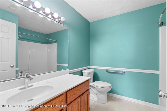 1101 Boulder Ct Unit 48, Lansing, MI 48917 - bathroom featuring a shower, toilet, vanity, a textured ceiling, and baseboards