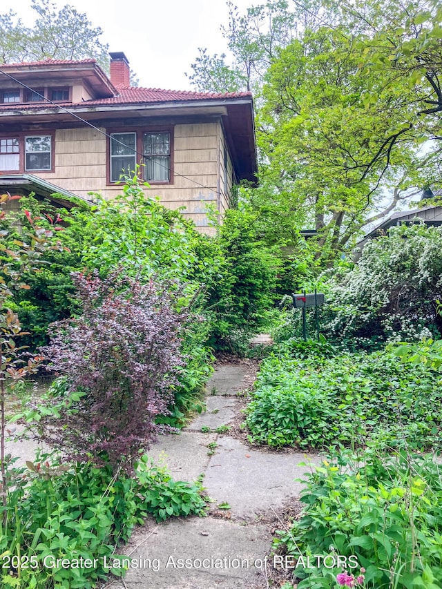 908 N Capitol Ave, Lansing, MI 48906 - view of home's exterior featuring a chimney