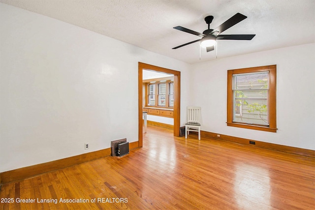 2104 Clifton Ave, Lansing, MI 48910 - spare room featuring light wood-style flooring, baseboards, healthy amount of natural light, and ceiling fan