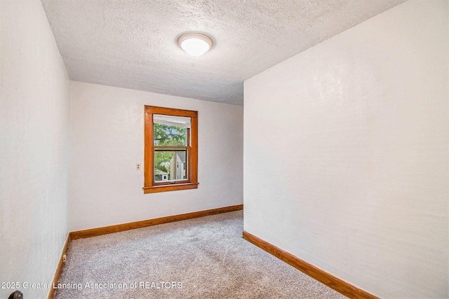 2104 Clifton Ave, Lansing, MI 48910 - carpeted spare room with a textured ceiling and baseboards