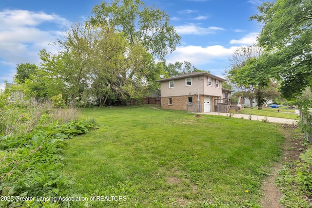 1021 Kendon Dr, Lansing, MI 48910 - view of yard with an attached garage and driveway
