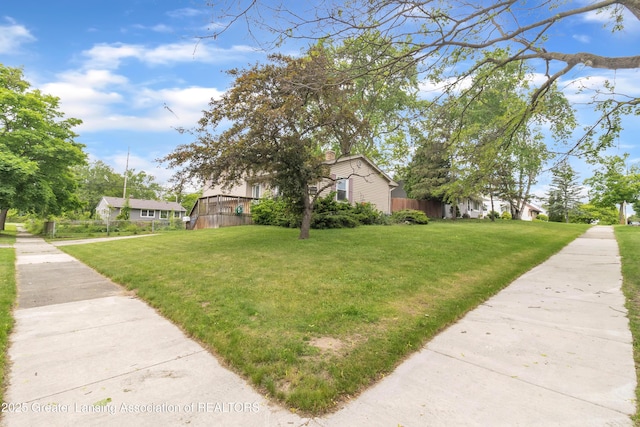 1021 Kendon Dr, Lansing, MI 48910 - view of home's exterior featuring a lawn