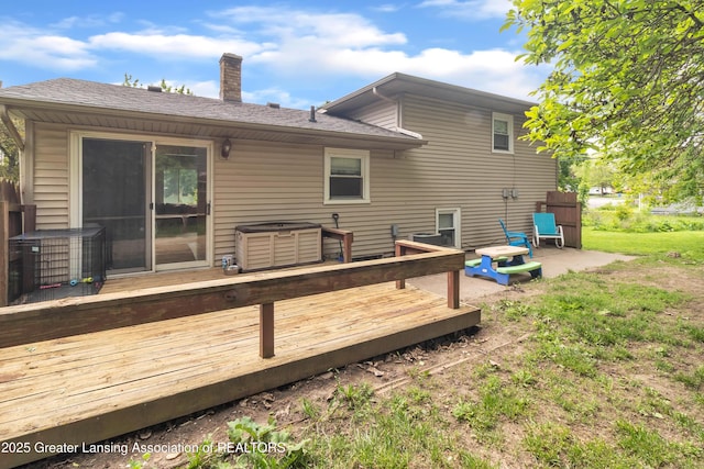 1021 Kendon Dr, Lansing, MI 48910 - rear view of house featuring a chimney, a deck, central AC unit, and a shingled roof