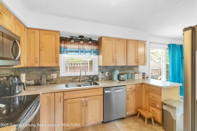 1021 Kendon Dr, Lansing, MI 48910 - kitchen with appliances with stainless steel finishes, a sink, and light brown cabinetry