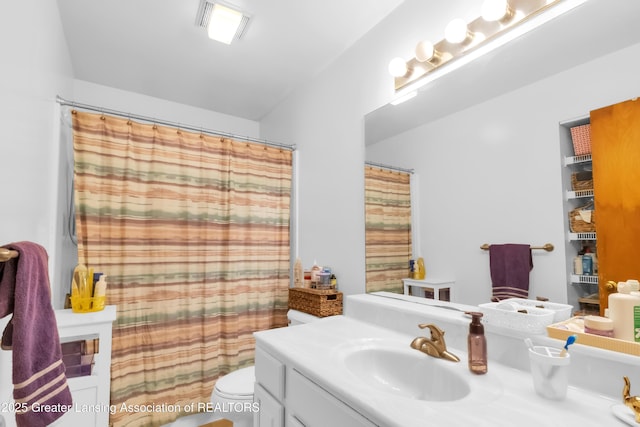 1021 Kendon Dr, Lansing, MI 48910 - full bathroom featuring vanity, toilet, and a shower with shower curtain