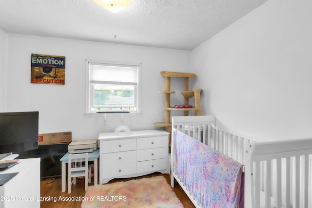 1021 Kendon Dr, Lansing, MI 48910 - bedroom with wood finished floors and a textured ceiling