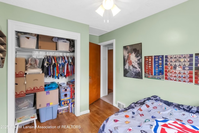1021 Kendon Dr, Lansing, MI 48910 - bedroom with a closet, wood finished floors, baseboards, and a ceiling fan