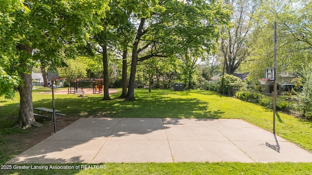 621 Ridgewood Ave, Lansing, MI 48910 - view of property's community featuring a lawn, a playground, and view of wooded area