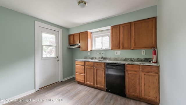 621 Ridgewood Ave, Lansing, MI 48910 - kitchen featuring black dishwasher, a sink, light wood finished floors, brown cabinets, and baseboards