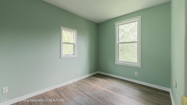 621 Ridgewood Ave, Lansing, MI 48910 - unfurnished room featuring healthy amount of natural light, wood finished floors, and baseboards