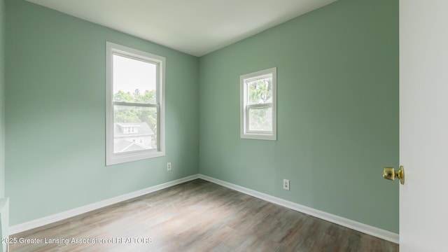 621 Ridgewood Ave, Lansing, MI 48910 - empty room featuring wood finished floors and baseboards