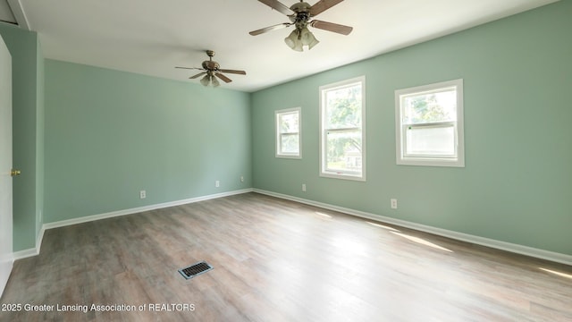 621 Ridgewood Ave, Lansing, MI 48910 - spare room featuring wood finished floors, a ceiling fan, and baseboards