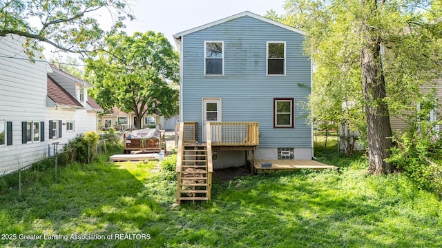 621 Ridgewood Ave, Lansing, MI 48910 - rear view of property with a wooden deck, a lawn, and stairs