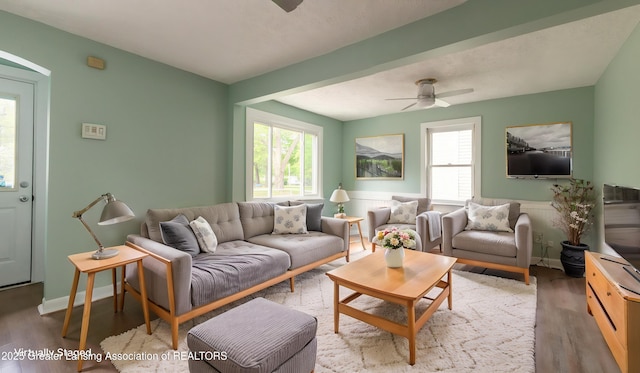 621 Ridgewood Ave, Lansing, MI 48910 - living room featuring a ceiling fan, wood finished floors, plenty of natural light, and wainscoting