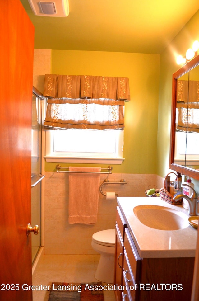 1161 Rebecca Rd, East Lansing, MI 48823 - full bath featuring vanity, toilet, tile walls, and an enclosed shower