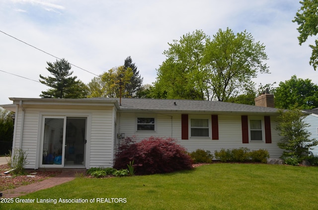 1161 Rebecca Rd, East Lansing, MI 48823 - rear view of property featuring a chimney and a yard