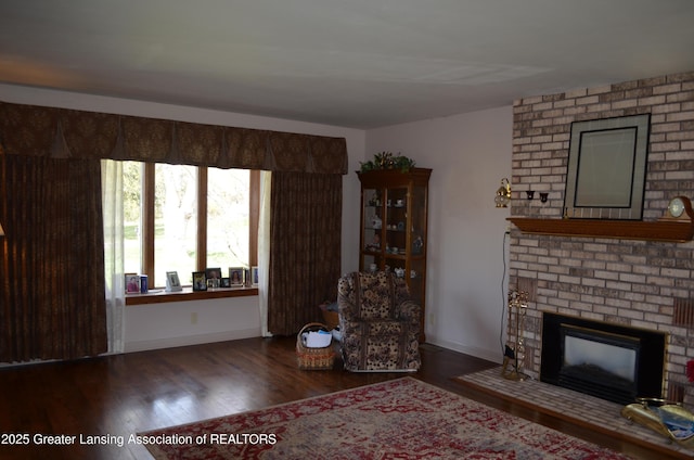 1161 Rebecca Rd, East Lansing, MI 48823 - living area with wood finished floors, a fireplace, and baseboards