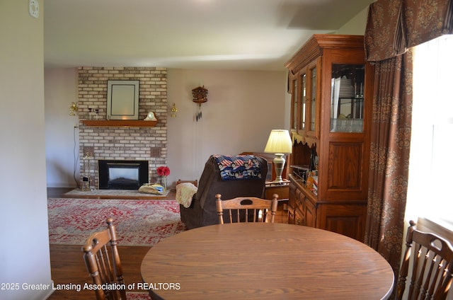 1161 Rebecca Rd, East Lansing, MI 48823 - dining area with a brick fireplace and wood finished floors
