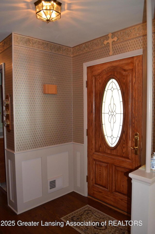 1161 Rebecca Rd, East Lansing, MI 48823 - entrance foyer with a wainscoted wall, dark wood-style floors, and wallpapered walls