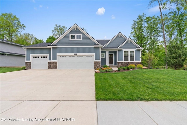 6619 Windford Ln, Grand Ledge, MI 48837 - craftsman-style house with stone siding, an attached garage, driveway, and a front yard