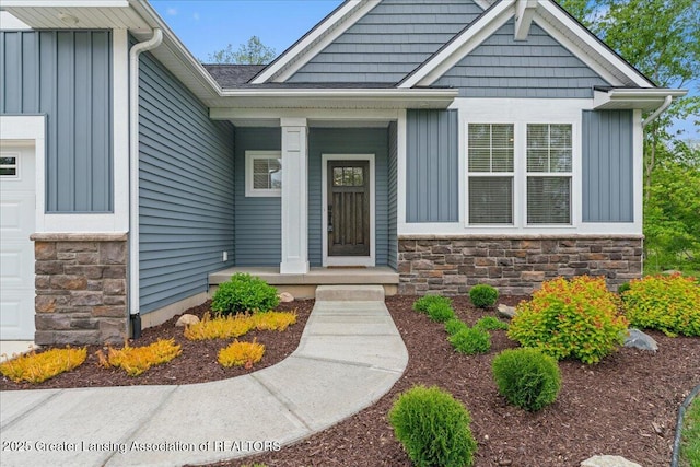 6619 Windford Ln, Grand Ledge, MI 48837 - view of exterior entry with board and batten siding and stone siding