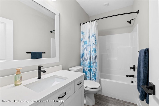 6619 Windford Ln, Grand Ledge, MI 48837 - full bath featuring vanity, toilet, shower / tub combo with curtain, and wood finished floors