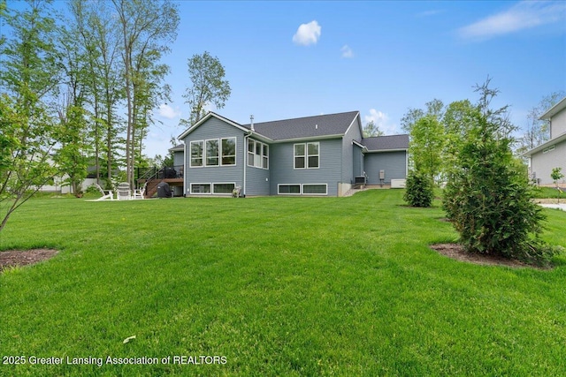 6619 Windford Ln, Grand Ledge, MI 48837 - rear view of property with a lawn
