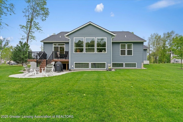 6619 Windford Ln, Grand Ledge, MI 48837 - rear view of house featuring a patio, a wooden deck, and a yard