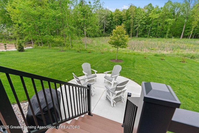 6619 Windford Ln, Grand Ledge, MI 48837 - wooden deck with a patio area, a yard, and a fire pit