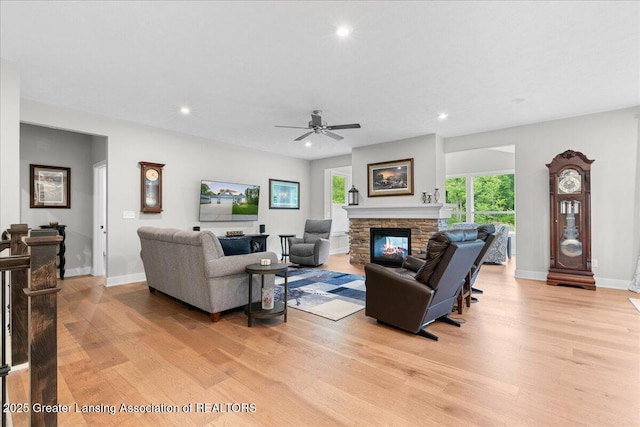 6619 Windford Ln, Grand Ledge, MI 48837 - living room featuring light wood-type flooring, baseboards, a stone fireplace, and recessed lighting