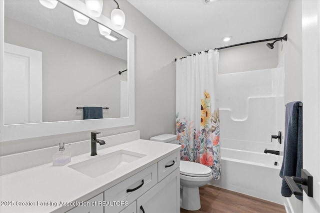 6619 Windford Ln, Grand Ledge, MI 48837 - full bath with wood finished floors, toilet, vanity, and shower / tub combo with curtain