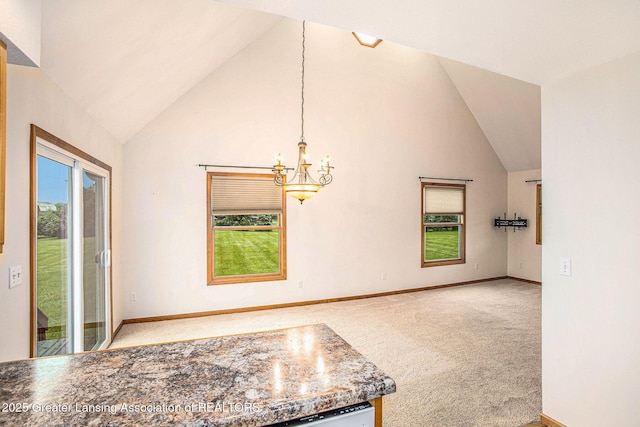3037 Hawley Rd, Leslie, MI 49251 - unfurnished dining area featuring carpet, a chandelier, baseboards, and high vaulted ceiling